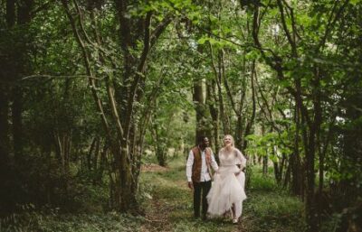 a couple walking through the woods at oakley