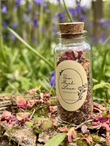 Bottle of wildflower seed confetti in a woodland