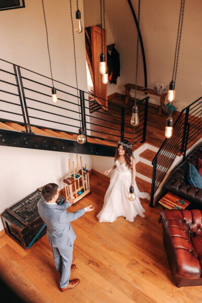 a bride and groom greet each other inside their wedding accommodation - a converted WW2 Nissen Hut at The Woods at Oakley