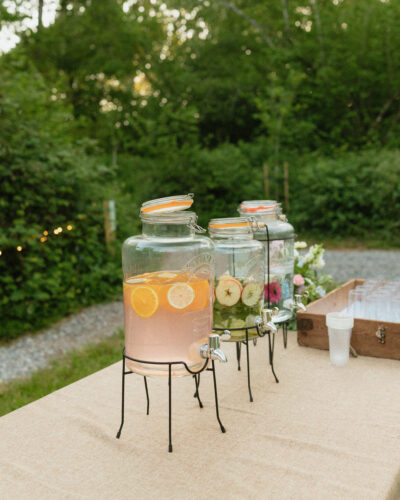Water jugs on a table in a woodland wedding venue