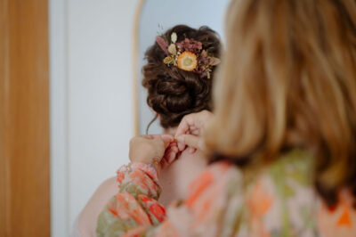 A bride having her hair done in an up-do