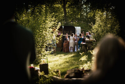 Woodland wedding guests in a woodland clearing