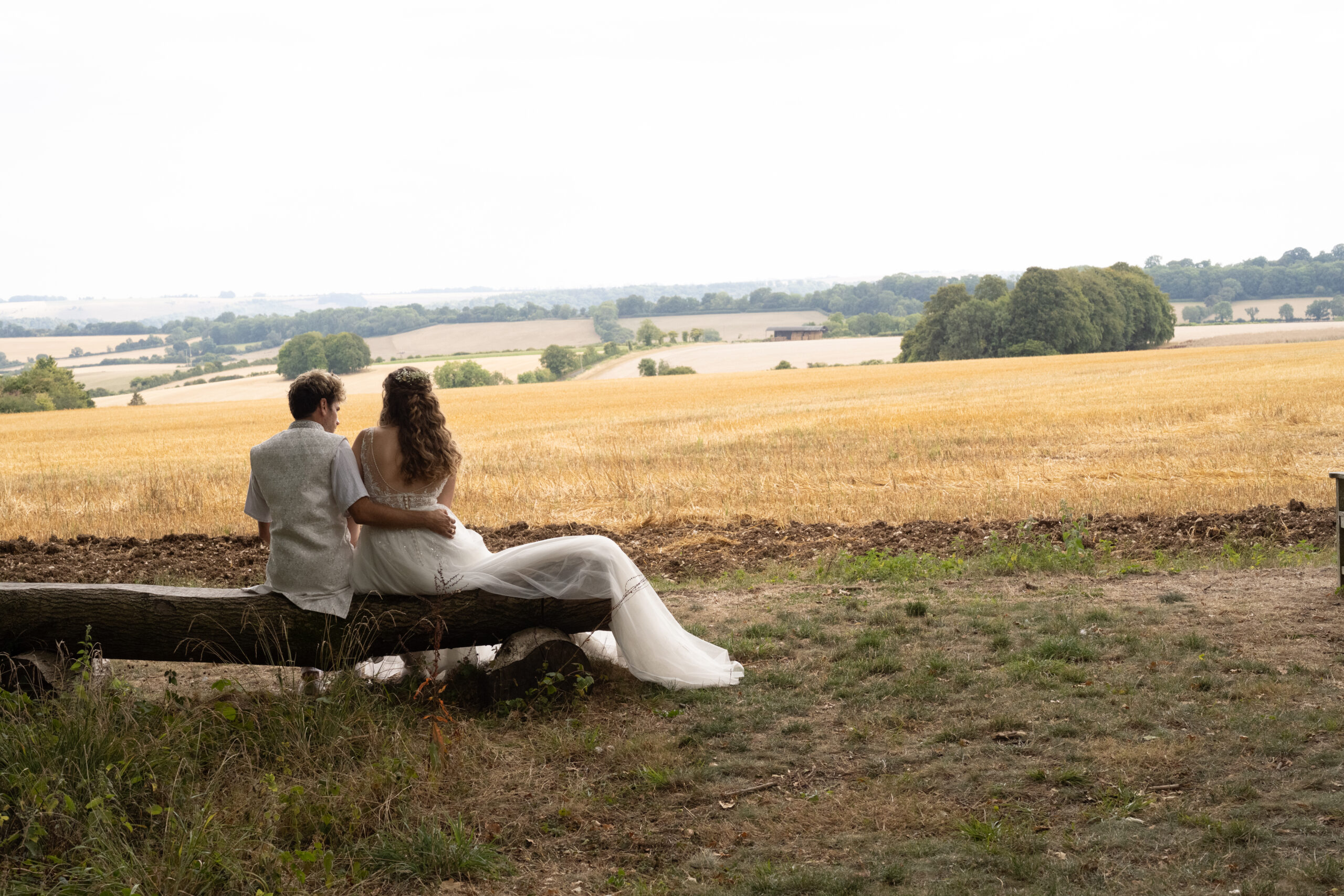 Couple sitting on a bench watching the sunset